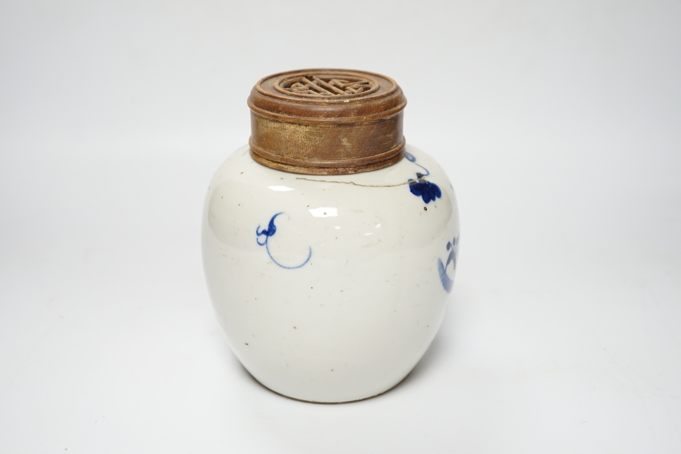 A Chinese blue and white jar, 19th century, with pierced hardwood lid, 15cm high